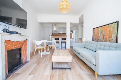 un salon avec un canapé et une cheminée dans l'établissement Le Castellane coeur centre ville, à Marseille