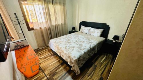 a small bedroom with a bed and a window at House Capo in Martil