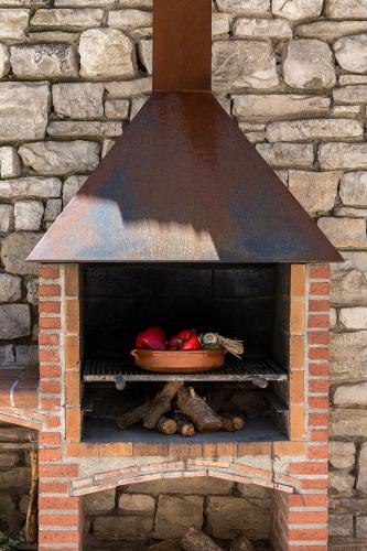 a brick oven with a bowl of vegetables in it at Cal Carulla in L'Astor