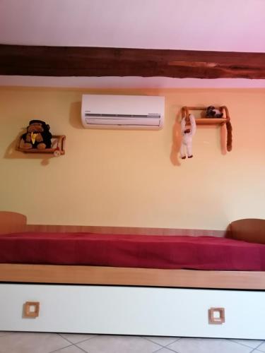 a room with a long red bench and a heater at La Girandola in Soriano nel Cimino