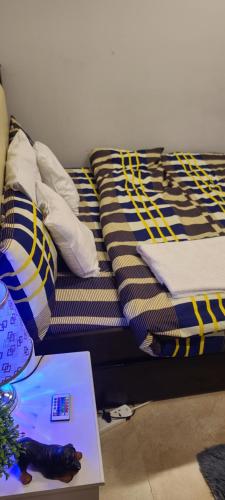 a bed with pillows and a book on the floor at Home Away Apartment in Abu Dhabi