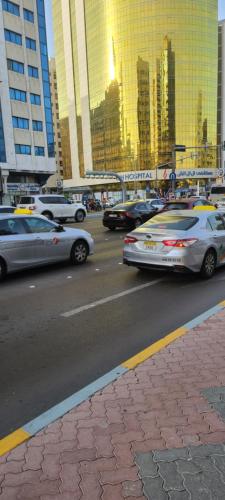 a group of cars driving down a city street at Home Away Apartment in Abu Dhabi