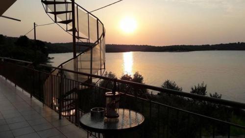 a fire hydrant on a balcony with a view of a river at ARTE MARE d'Irene in Spárton