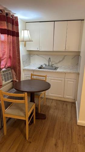 a kitchen with a table and chairs and a sink at Gaard motel in Foxborough