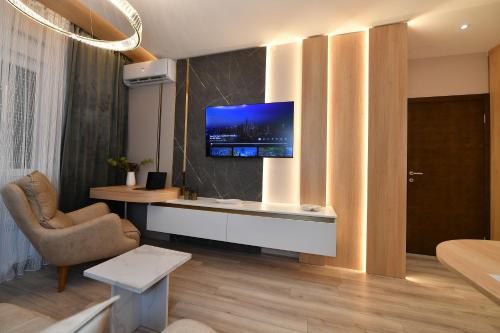 a living room with a television on a wall at Metropolitan Royal in Jagodina