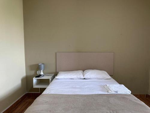 a bedroom with a large bed with a night stand at Royal Hotel e Gastronomia Macapá in Macapá