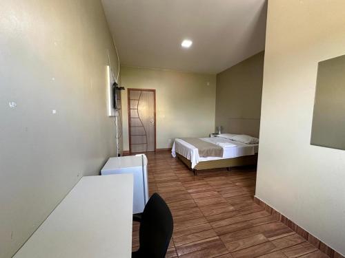 a bedroom with a bed and a table in a room at Royal Hotel e Gastronomia Macapá in Macapá