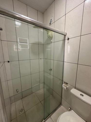 a bathroom with a glass shower with a toilet at Royal Hotel e Gastronomia Macapá in Macapá