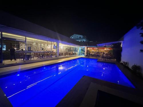 a large swimming pool at night with blue lights at Royal Hotel e Gastronomia Macapá in Macapá