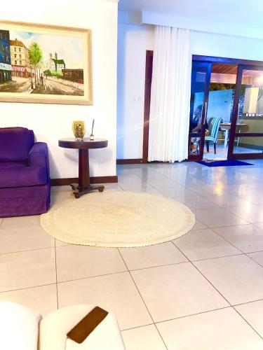 a living room with a couch and a table at Casa bela in Lauro de Freitas