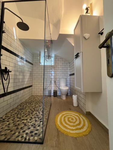 a bathroom with a shower and a toilet at Αλμα - A Family boutique apartment at the city center in Kalamata