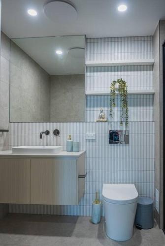 a bathroom with a toilet and a sink at Lux Lakeside Apt - Gold Coast in Gold Coast