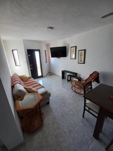 a living room with a couch and a flat screen tv at Lo de Vicente in Pergamino