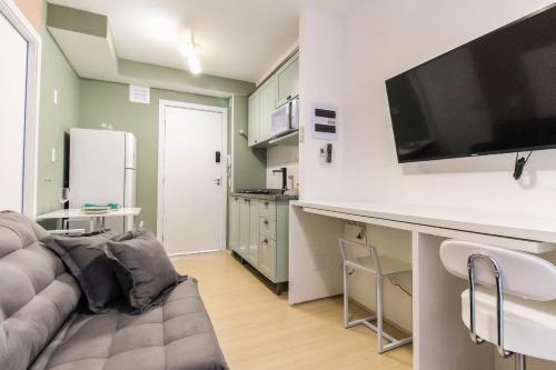 a living room with a couch and a flat screen tv at MO806 - Apto Lindo na Mooca in Sao Paulo