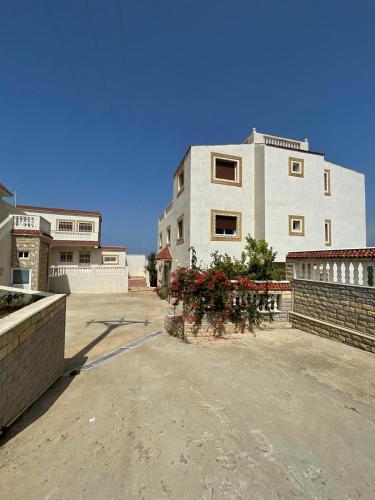 a large white building with flowers in front of it at villa victoria in Tetouan