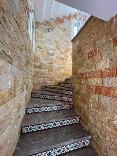 a staircase in a building with a brick wall at villa victoria in Tetouan