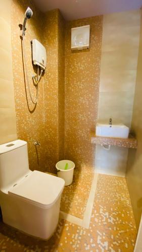 a bathroom with a toilet and a sink at Vicente Aguirre Rooms in Boracay