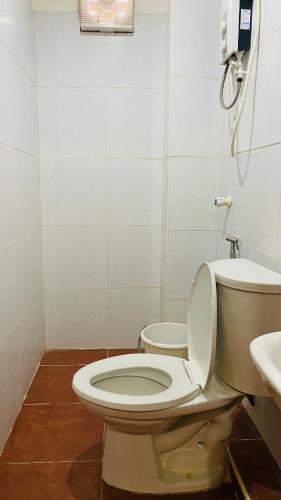 a bathroom with a toilet and a sink at Vicente Aguirre Rooms in Boracay