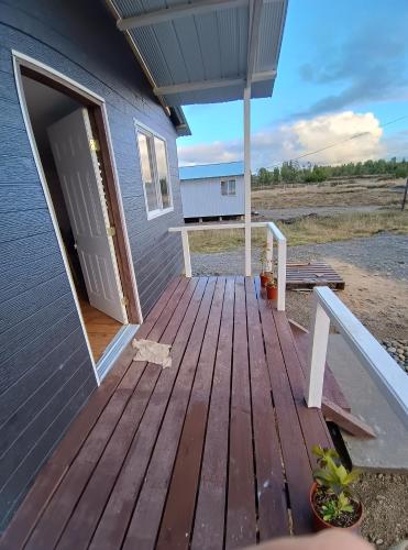 an open door to a house with a deck at Cabañas Florynella in Ilque