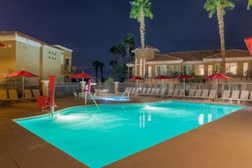 a large swimming pool in a resort at night at Marriott Desert Springs II Luxury Guest Room in Palm Desert