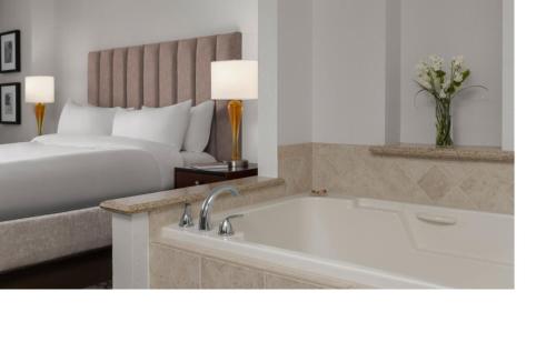 a hotel room with a bed and a bath tub at Marriott Grand Chateau 2BD in Las Vegas