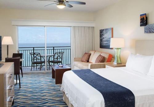a hotel room with a bed and a balcony at Marriott BeachPlace Towers Luxury Guest Room in Fort Lauderdale