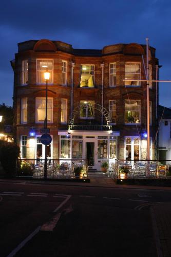a large brick building with lights on a street at The Seaview Hotel And Restaurant in Seaview