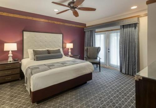 a bedroom with a large bed with a ceiling fan at Make Yellowstone memories with the family in this 2BD vacation condo in West Yellowstone