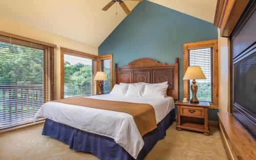 a bedroom with a large bed and two windows at Worldmark Galena - 1BD in Galena