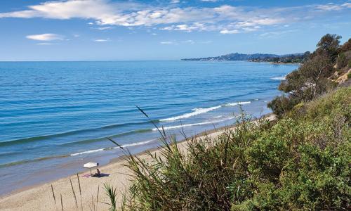a beach with an umbrella and the ocean at WorldMark Solvang - 2BD Sleeps up to 6 in Solvang