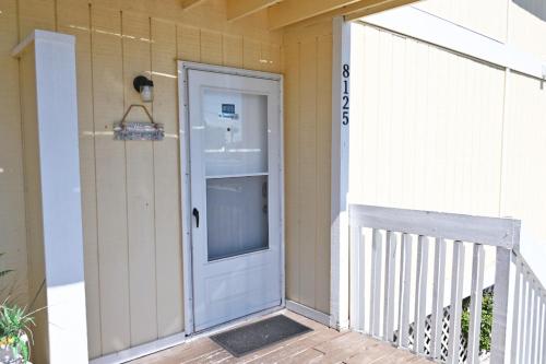 a white door on a house with a porch at Sandpiper Cove Unit 8125 Updated Studio In Destin FL in Destin
