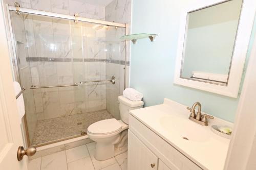 a bathroom with a shower and a toilet and a sink at Sandpiper Cove Unit 8125 Updated Studio In Destin FL in Destin