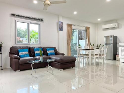 a living room with a couch and a table at Chalong - 2 Bedroom Hideaway Private Pool Villa - Phuket in Chalong 