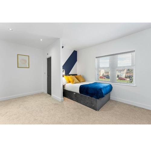 a bedroom with a bed and a window in it at Westland House En-suite Whole in Peterborough
