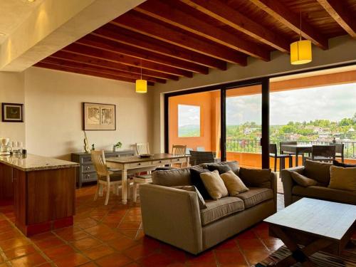 a living room with a couch and a table at Spacious No Stairs Gated Community Pool Parking Gym in San Miguel de Allende