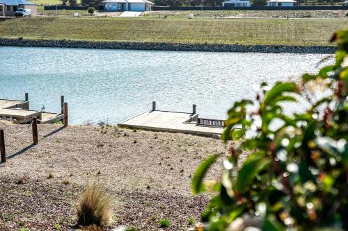 a large body of water with a dock at 32 Blanche Pde Hindmarsh Island - No Linen Included in Hindmarsh Island