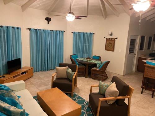 a living room with a couch and a table at Falmouth Sea View Loft in Falmouth