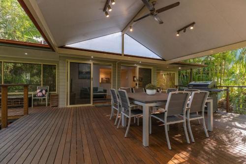 a patio with a table and chairs on a deck at Allawah at Smiths Lake in Smiths Lake