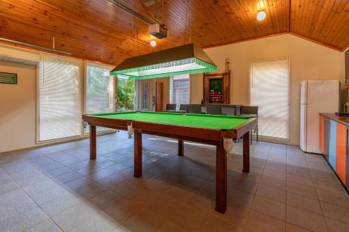 a kitchen with a pool table in a room at Allawah at Smiths Lake in Smiths Lake