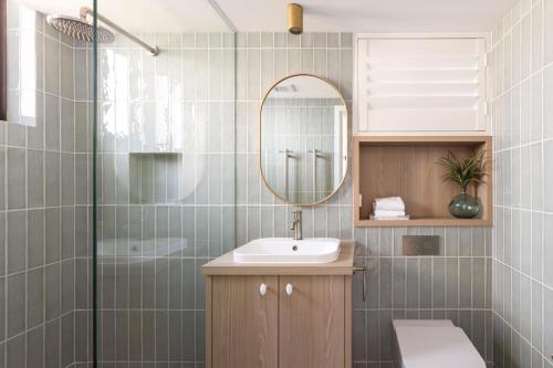 a bathroom with a sink and a mirror at Columbia Beachfront Apartments on Rainbow Bay in Gold Coast