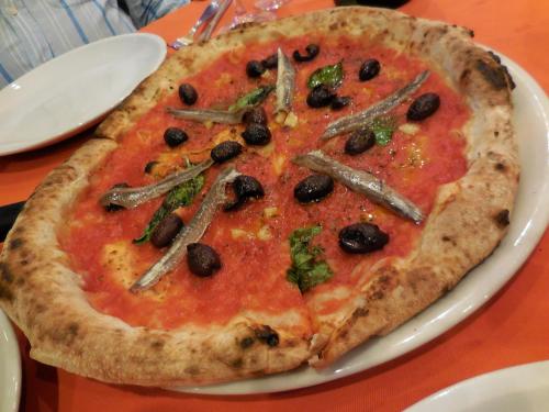 a pizza on a white plate on a table at Tenuta Montelaura in Forino