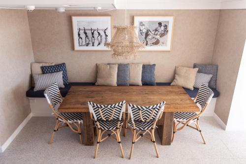 a dining room with a wooden table and chairs at Columbia Beachfront Apartments on Rainbow Bay in Gold Coast