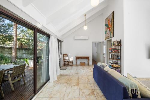 a living room with a couch and a table at Valley Hideaway - Whole House in Narrawallee