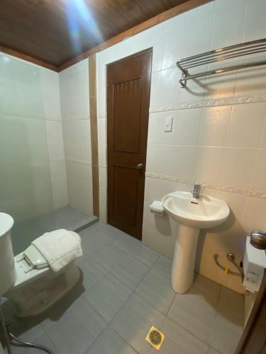 a bathroom with a sink and a toilet at Club Balai Isabel Villa Estalilla in Talisay