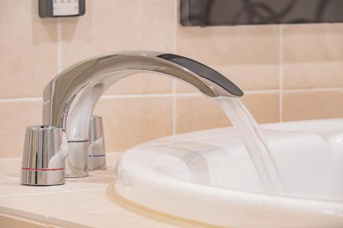 a sink with water running from a faucet at Elite Inn Kyoto Station エリートイン京都駅 in Kyoto