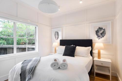 a bedroom with a bed with two towels on it at Howth - The Black House by TCC in Newport