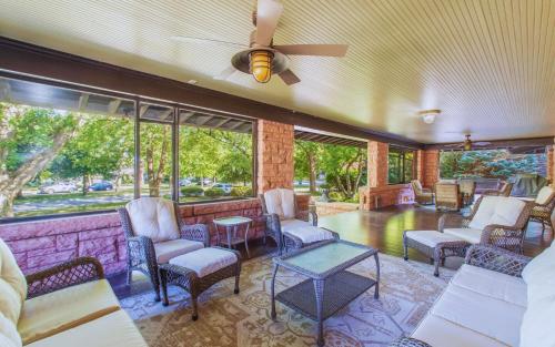 a living room with chairs and tables and windows at Martha's Bed and Breakfast in Lincoln