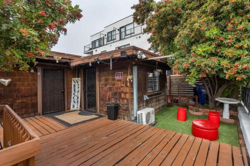 a backyard with a wooden deck with green grass at Spacious Guest Suite Amazing Location in San Diego