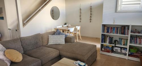 a living room with a couch and a table at Bec's Beach House Getaway in Batemans Bay