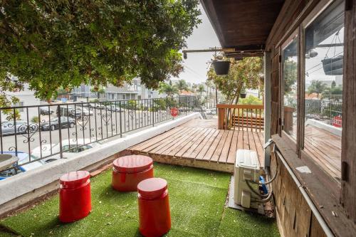 a porch with three red barrels on the grass at Big Studio with Ocean View max 6 sleepers in San Diego